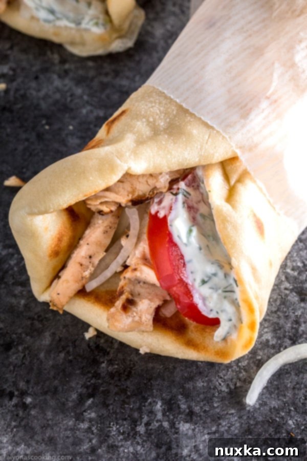 Delicious homemade chicken gyros served with creamy tzatziki sauce and fresh toppings