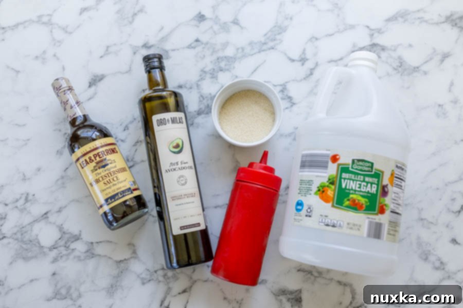 Ingredients for homemade Catalina Dressing (avocado oil, Worcestershire sauce, sugar, ketchup, and vinegar) 