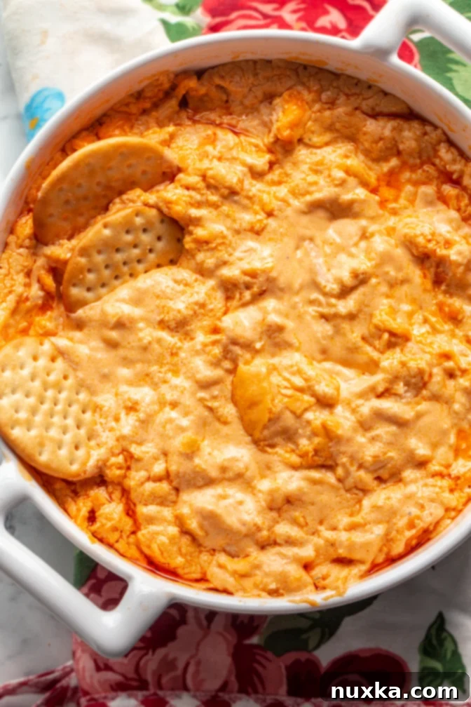 Extremely creamy Buffalo Chicken Dip recipe made with Frank's Red Hot Sauce, garnished with blue cheese crumbles