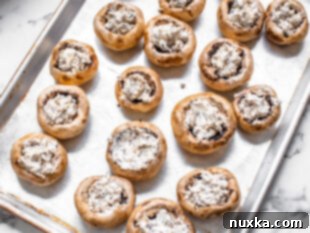 stuffed mushrooms caps on a baking sheet pan