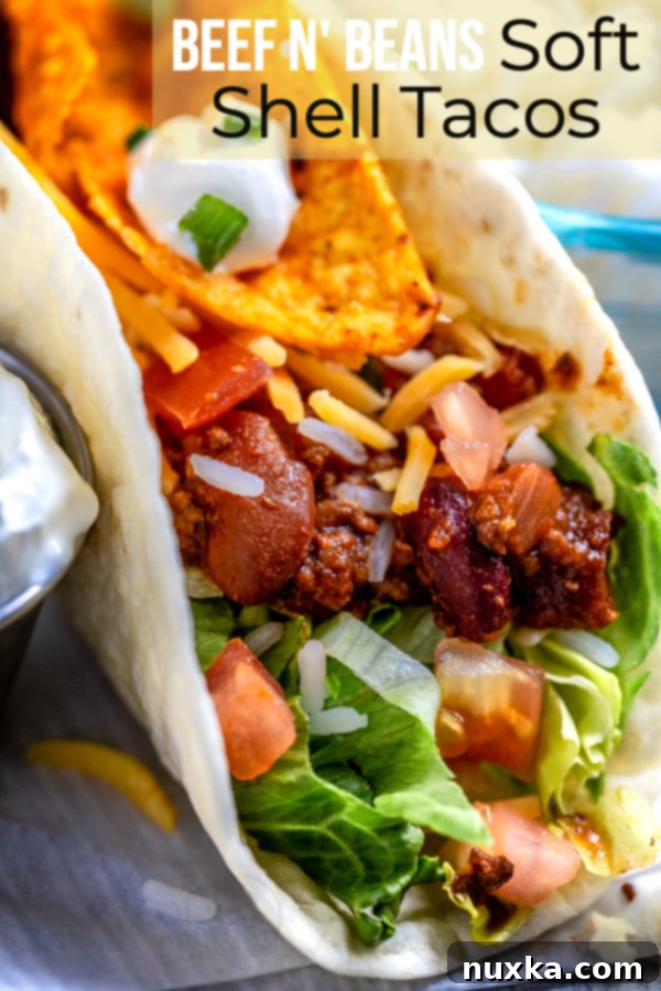 Assorted Soft Shell Tacos with Various Toppings, including a lime wedge and cilantro garnish