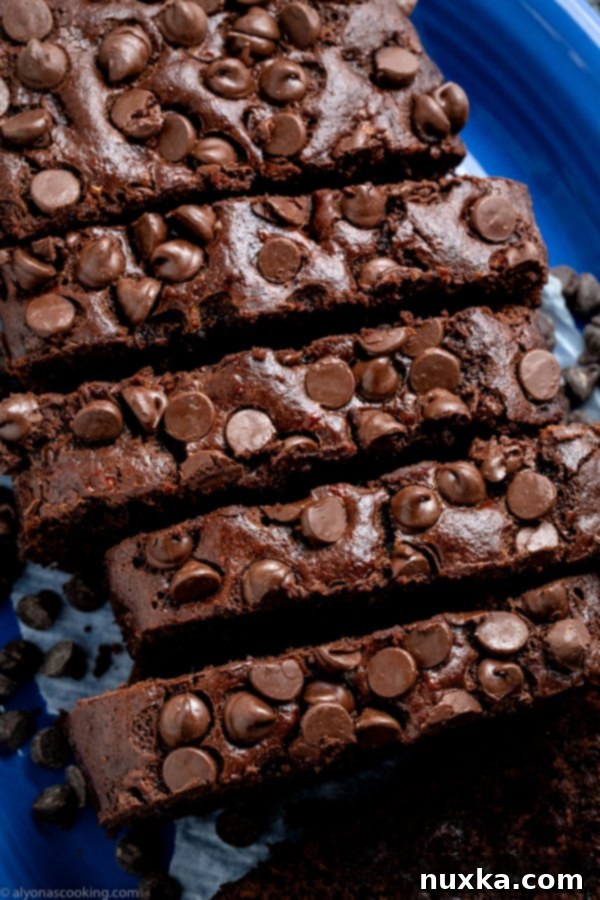 Deliciously moist chocolate banana bread slice on a cooling rack