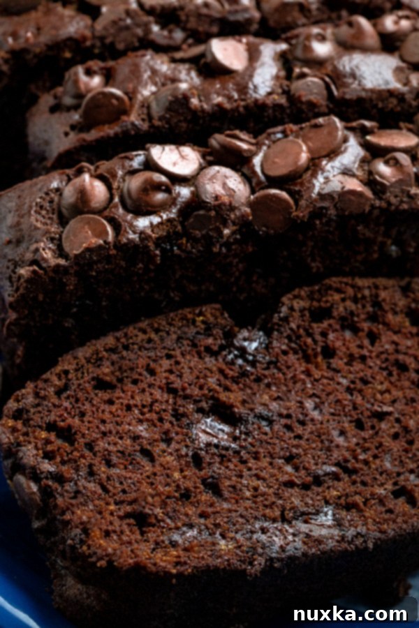Close-up of a slice of moist chocolate banana bread revealing chocolate chips