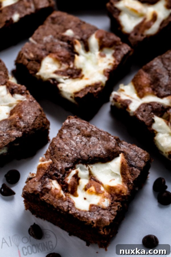 Close-up of baked cream cheese brownies showing the intricate cheesecake swirl patterns