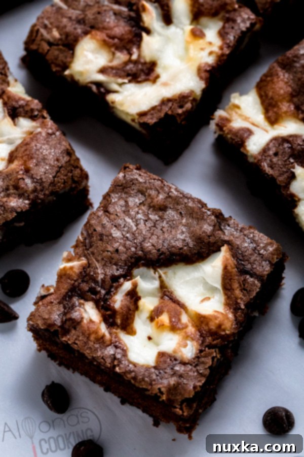 Deliciously moist cream cheese brownies with a distinct swirl, ready to be enjoyed
