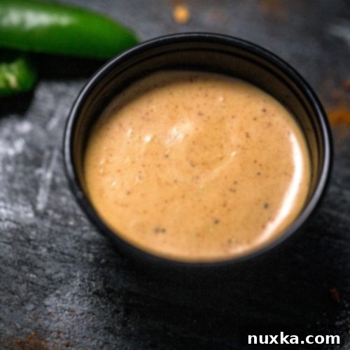 Taco Bell Creamy Jalapeno Quesadilla Sauce 3 A bowl of vibrant Taco Bell quesadilla sauce, ready to be served.
