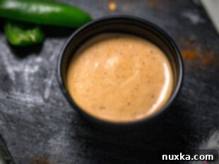 Taco Bell quesadilla sauce poured into a squeeze bottle for storage.