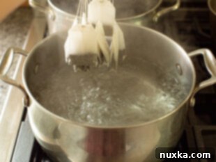 Tea bags steeping in hot water to brew the iced tea concentrate.