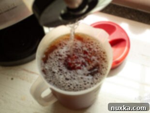 Hot tea concentrate being mixed with cold water to cool it down.