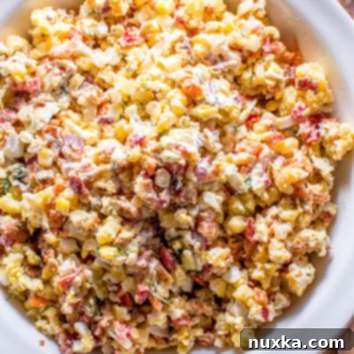 Decadent Bacon Potato Salad 4 Freshly made creamy bacon potato salad in a white bowl, ready to be served.