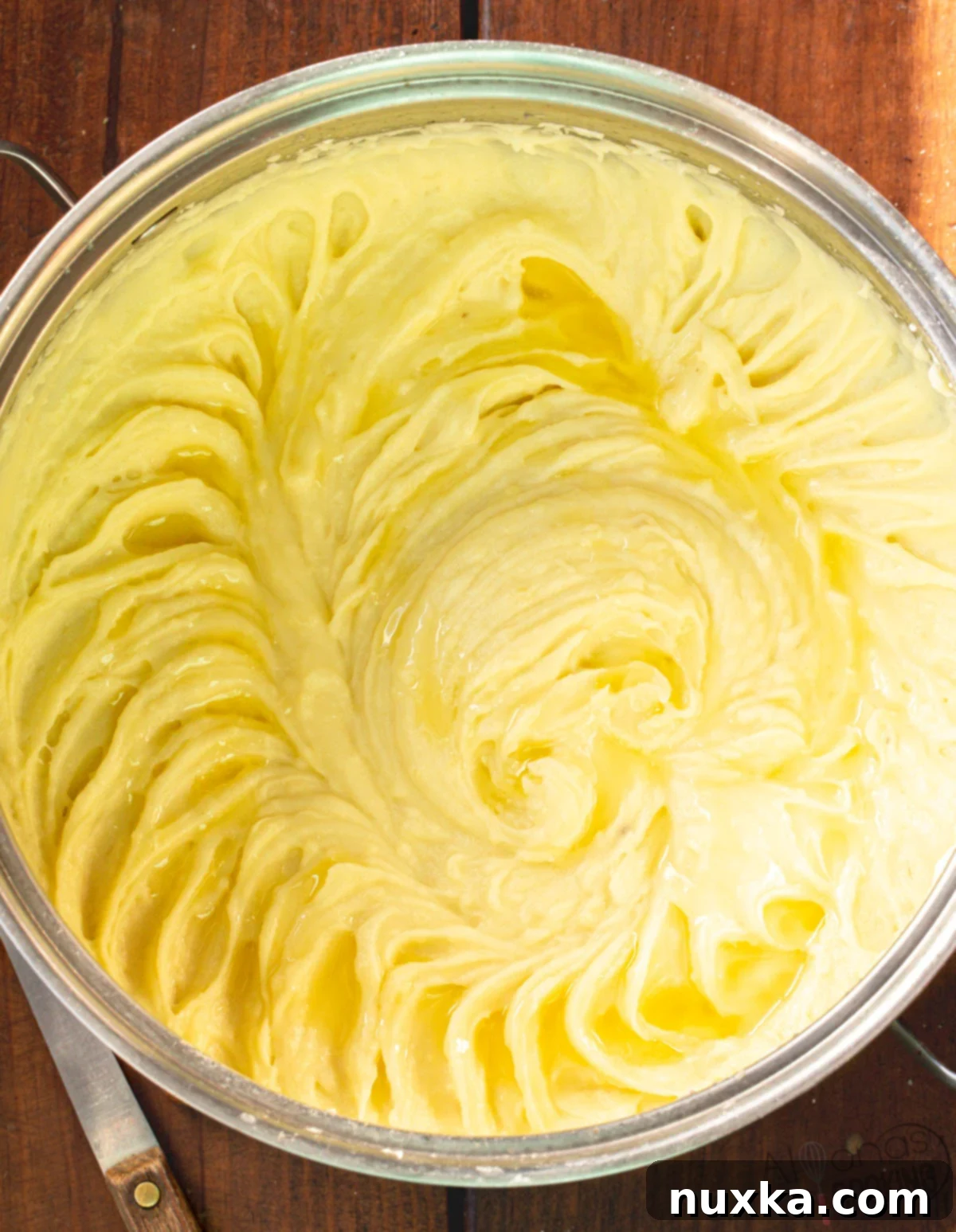 How to make the best creamy mashed potatoes recipe by mashing boiled potatoes in a pot with dairy