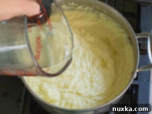 How to add salt, reserved potato water, and milk to mashed potatoes for perfect consistency