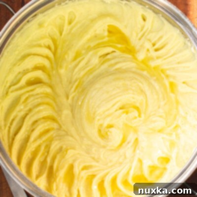 Perfect Mashed Potatoes 2 How to make the best creamy mashed potatoes recipe, showing potatoes being mashed in a pot
