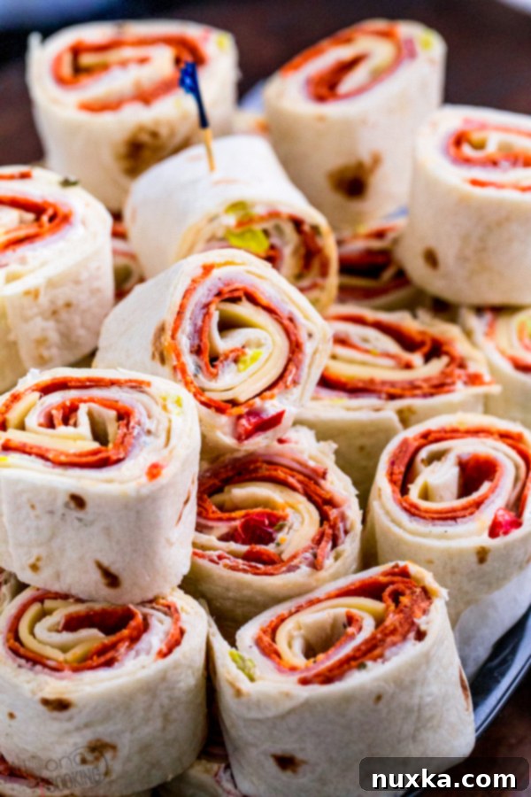 Assortment of Italian Pinwheels on a platter with dipping sauce