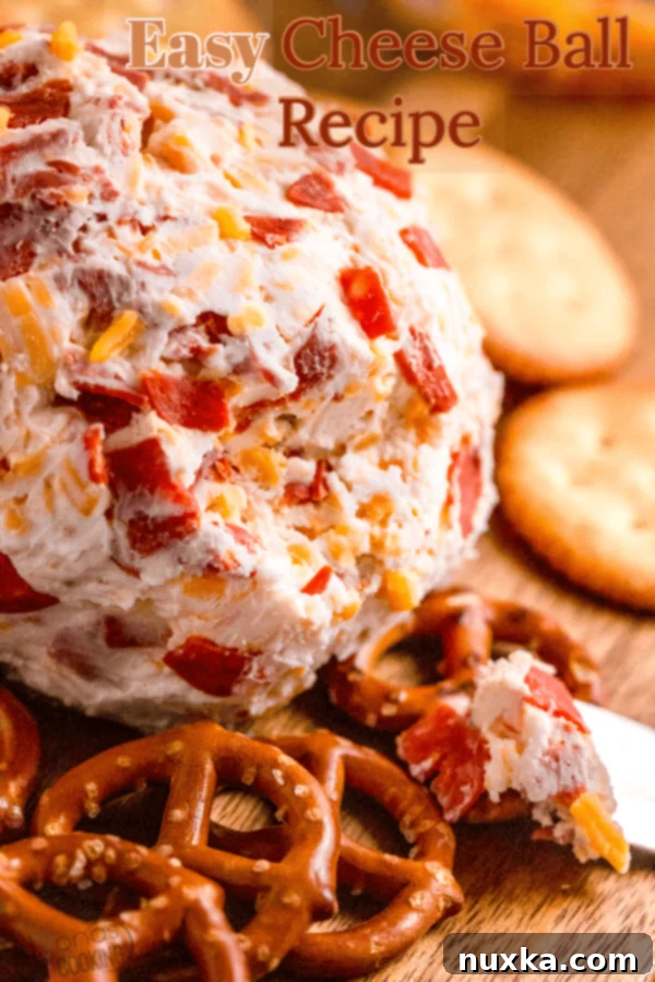 Cheese Ball ready to serve on a board with crackers