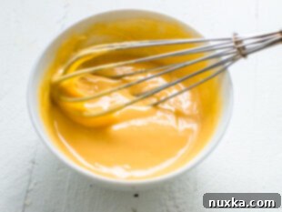 Melting cheese and milk in a bowl