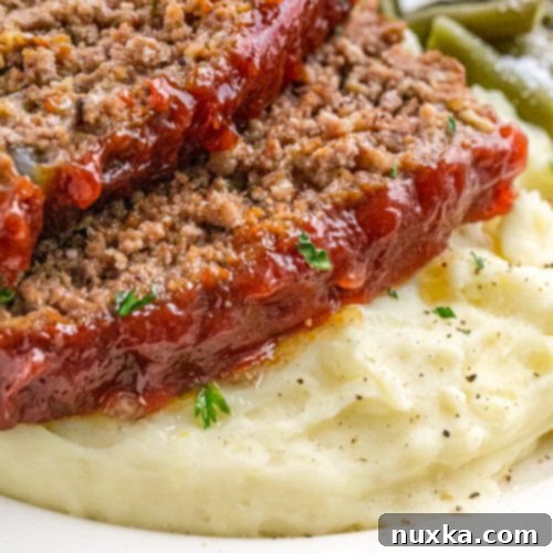 The finished easy gluten-free oatmeal meatloaf with a perfect glaze, sliced and ready to enjoy.