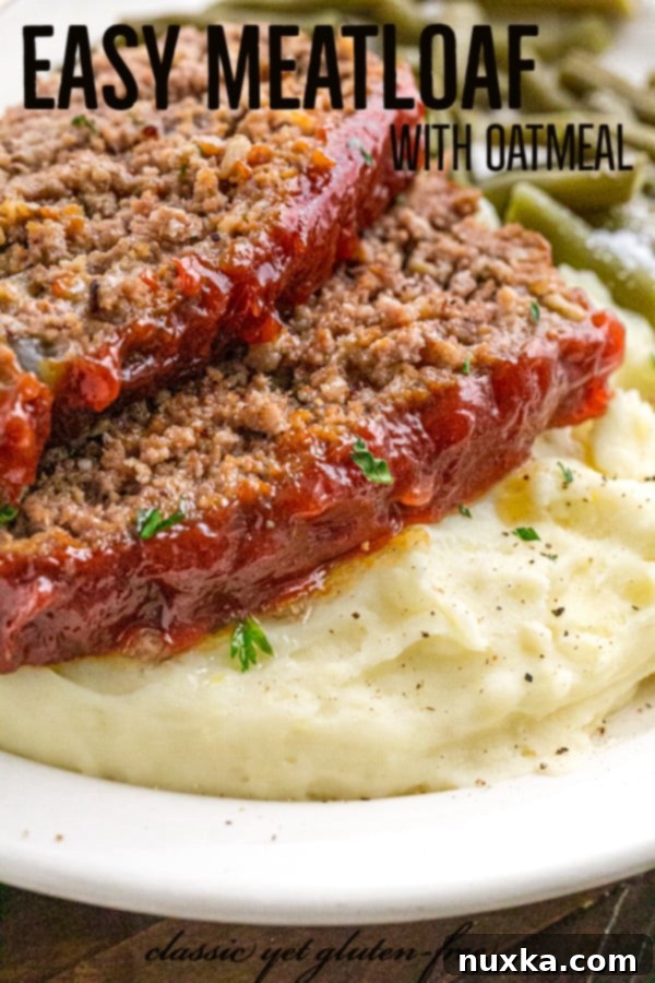 A perfectly baked, glazed meatloaf cooling in a loaf pan, ready for its resting period.