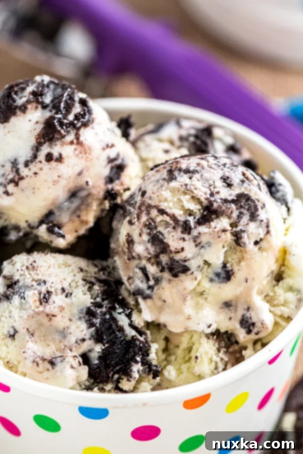 A scoop of homemade cookies and cream ice cream, showcasing the rich, creamy texture and generous chunks of chocolate sandwich cookies.