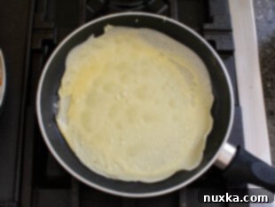 Preheating a non-stick skillet for cooking crepes.