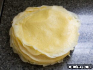 Ladle batter into pan and swirl to coat, then cook until edges crisp.