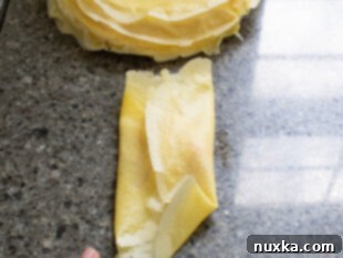 Folding a savory crepe into a pocket square.
