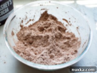 Cutting shortening into dry brownie mix ingredients.
