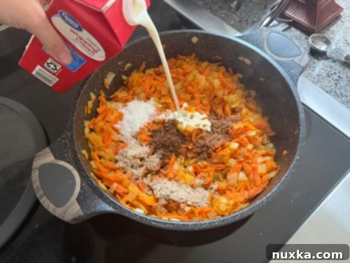 Cream-Infused Baked Potato Wedges 12 image of sautéed carrots and onions with mushroom bouillon cubes and heavy cream, forming the sauce base