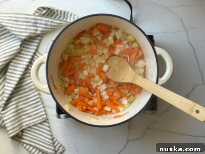 A colorful image of mirepoix, diced onions, carrots, and celery, ready to be cooked.