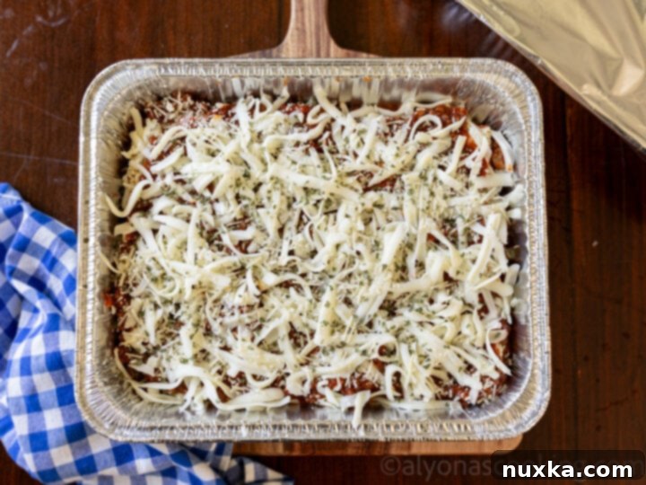 An image of assembled homemade lasagna, ready for the freezer.