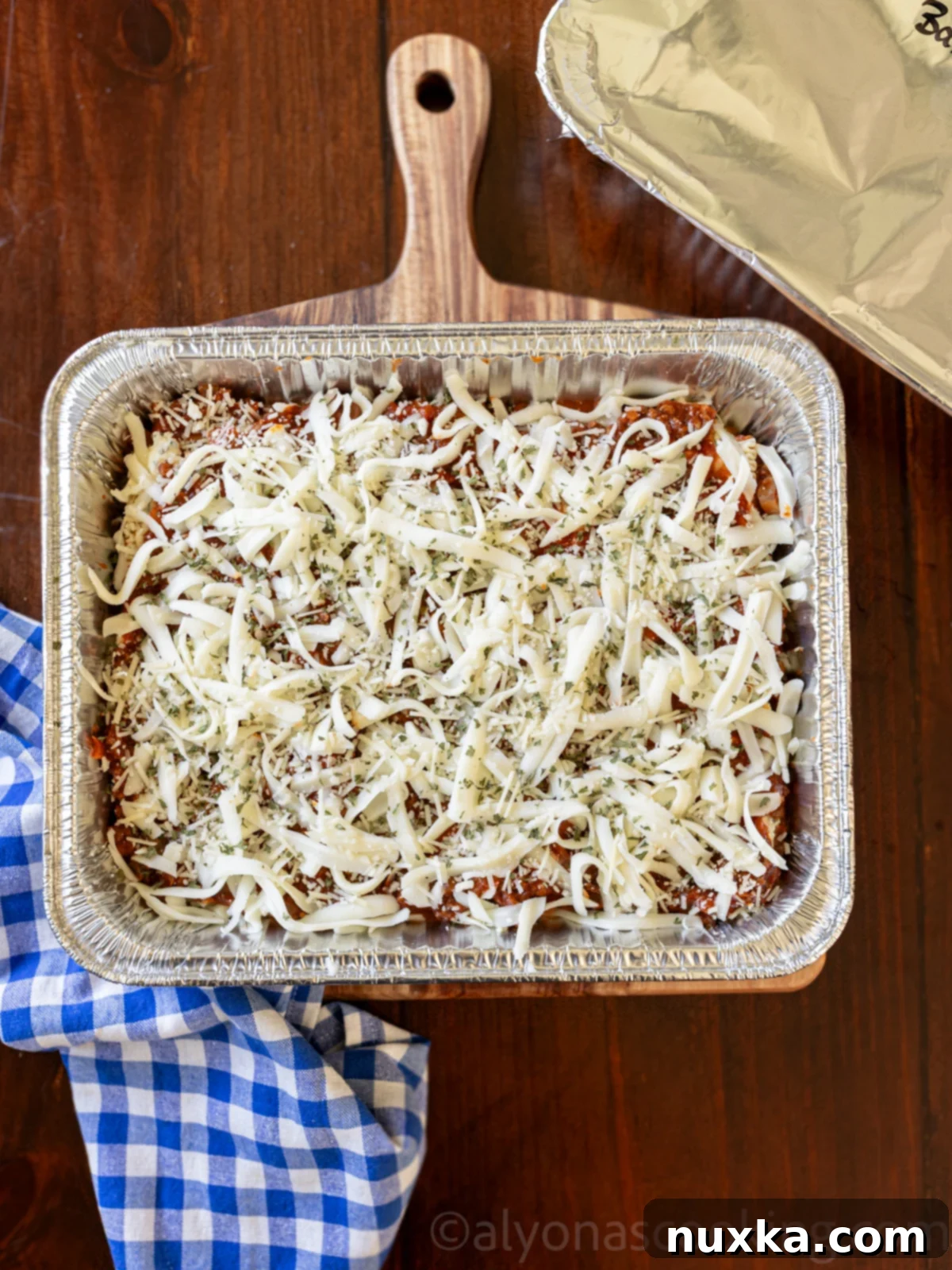 Cook Once, Eat All Week 2 Image showing the assembly, wrapping, and freezing process of a freezer lasagna