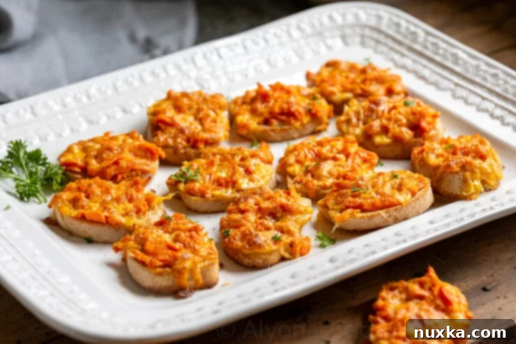 image of cheesy hot carrot sandwiches on a white platter 