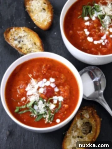 A bowl of easy homemade tomato soup, garnished with fresh basil.