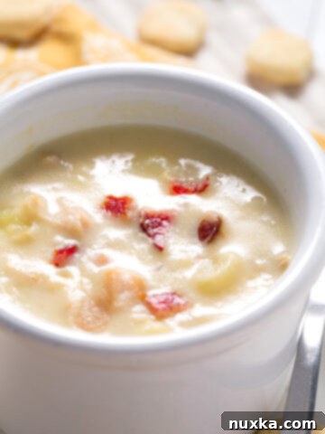 A hearty bowl of homemade clam chowder with crackers.