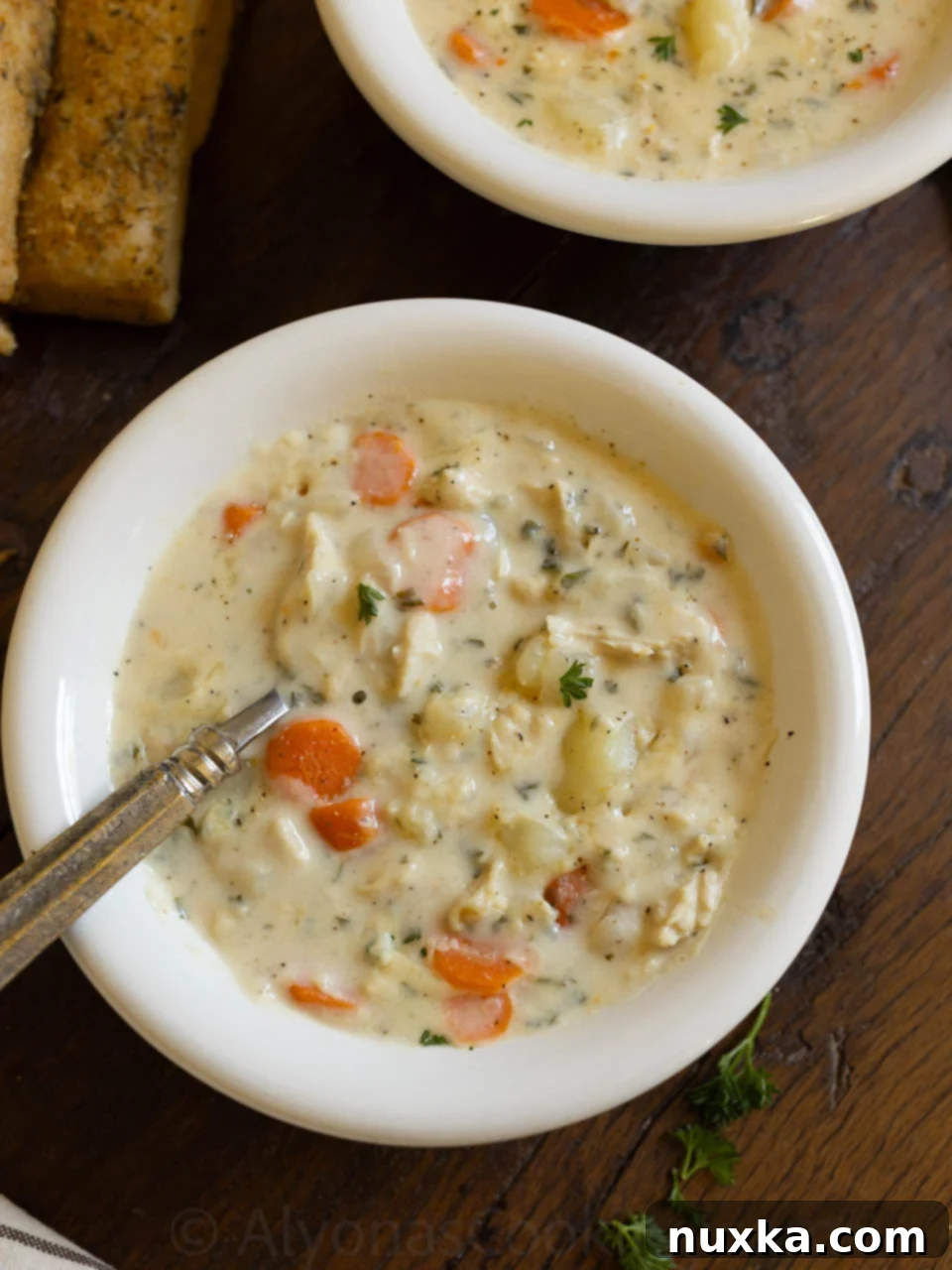 A large, inviting bowl of creamy chicken chowder, ready to be served.