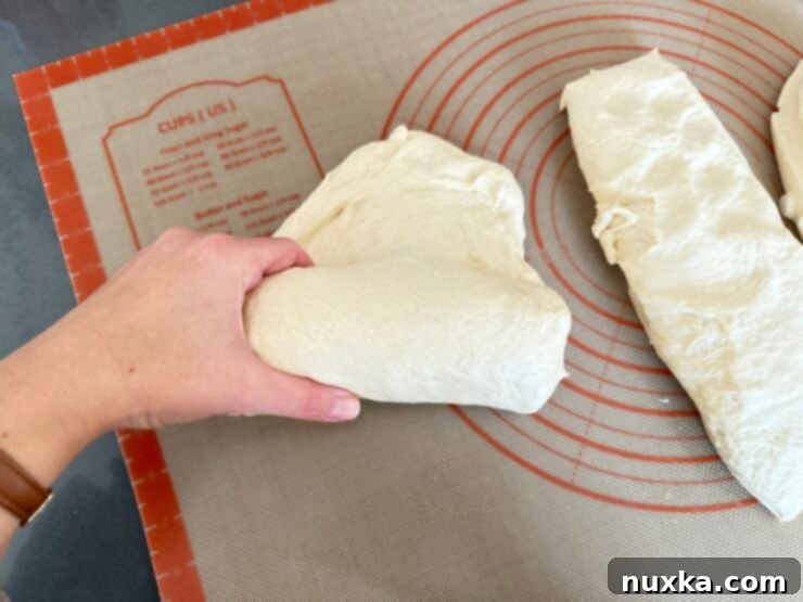 image of Alyona rolling the dough, jelly-roll style to make a sandwich loaf