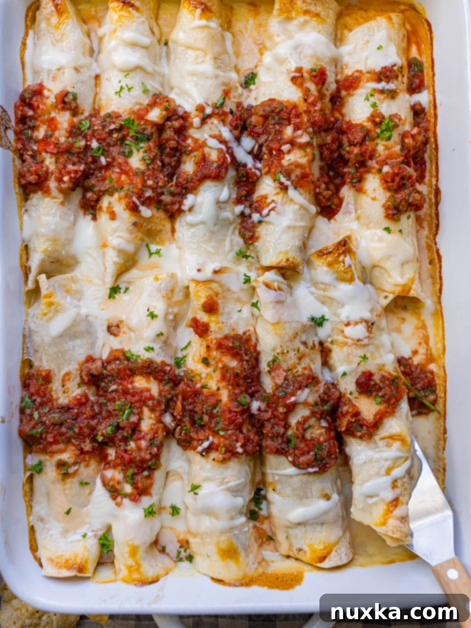 image of Instant pot chicken enchiladas with white melted cheese sauce and homemade salsa