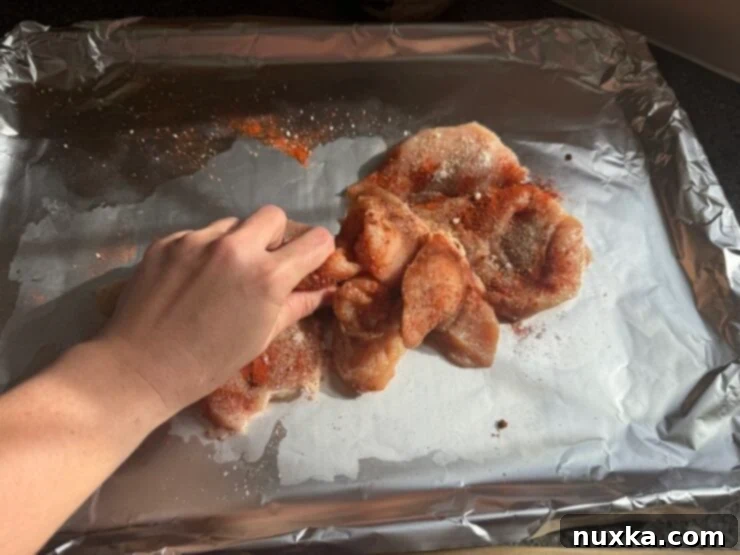 image of Alyona rubbing Italian chicken with her hands
