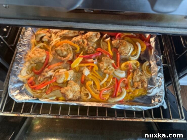 image of sheet pan Italian chicken roasted with bell peppers and onions in Italian Dressing