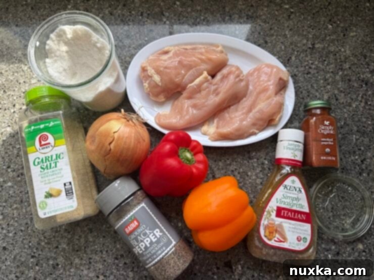 Ingredients for sheet pan Italian chicken and peppers: chicken breasts, Italian Dressing, colored bell peppers, onion, black pepper, smoked paprika, salt, and garlic salt.